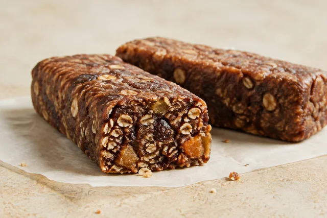 Date, fruit and oat bar cut to show the dense fruit binder and oat texture